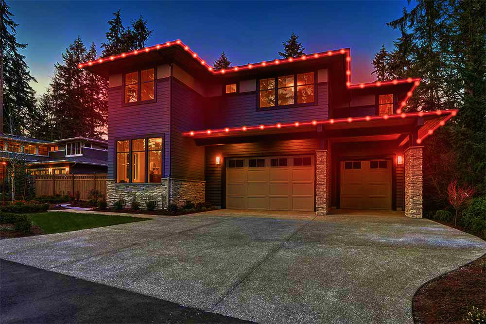 ShowHome lights following a two-storey home's roofline in red